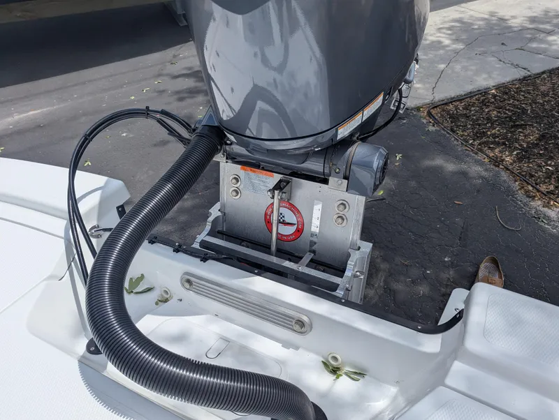 Slide: The Image of Outboard motor on a 2025 Frontier 2104 boat, showing engine mount and cables. - 18