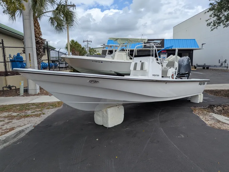 Slide: The Image of 2025 Frontier 2104 boat displayed outdoors on concrete blocks. - 19