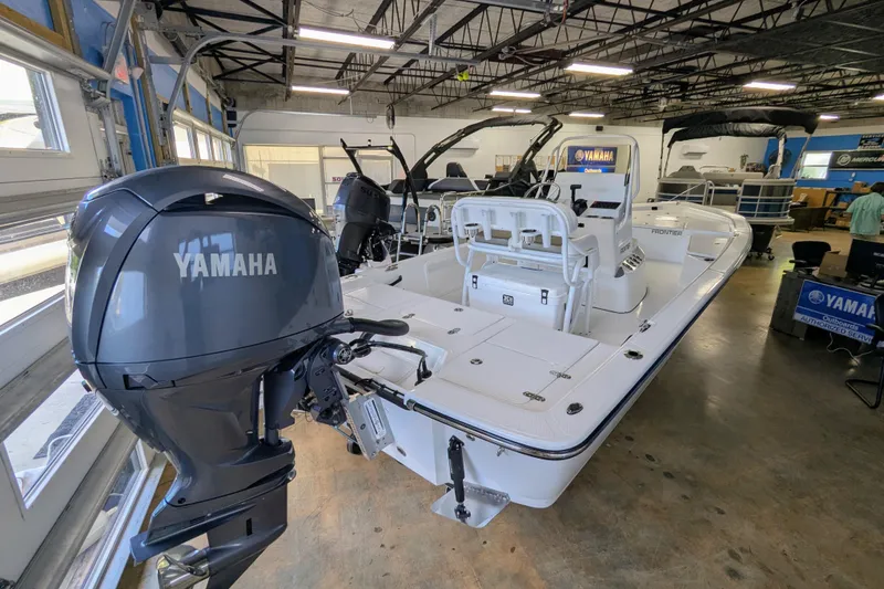 Slide: The Image of 2025 Frontier 2104 boat with Yamaha outboard motor in a showroom. - 4