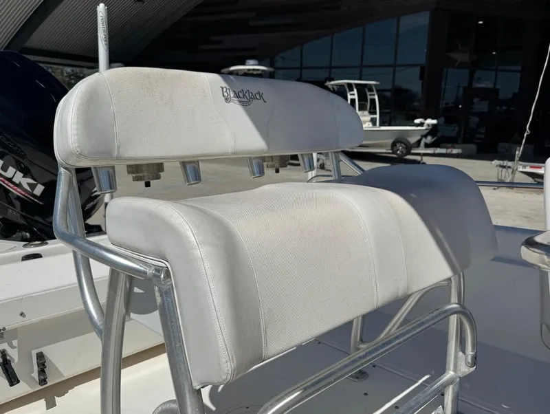 Slide: The Image of Boston Whaler 220 Dauntless 2002 boat seat with white upholstery and metal frame. - 16