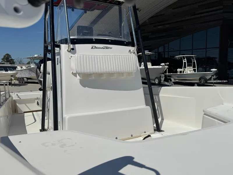 Slide: The Image of 2002 Boston Whaler 220 Dauntless boat, center console view, docked in a marina. - 21