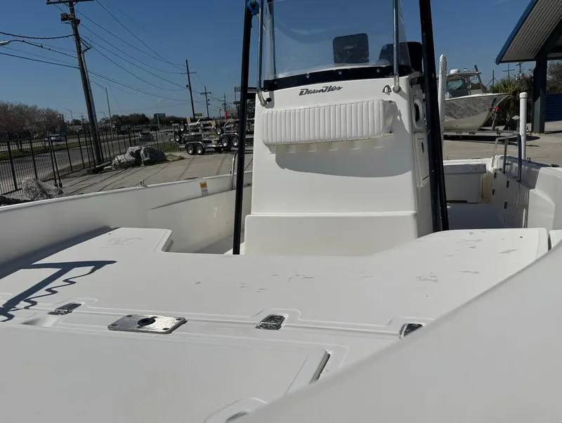 Slide: The Image of 2002 Boston Whaler 220 Dauntless boat, white deck, center console, outdoor setting. - 22