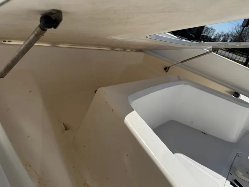 Slide: The Image of 2002 Boston Whaler 220 Dauntless interior storage compartment, open lid, white finish. - 24