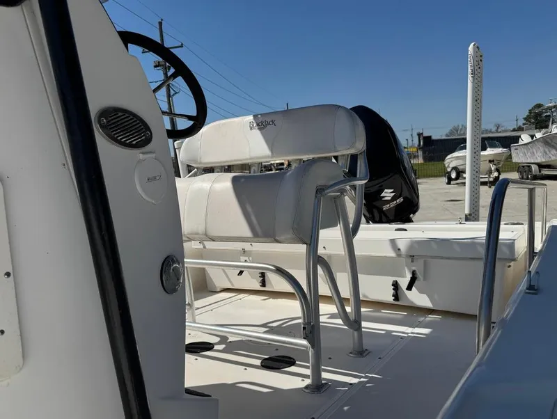 Slide: The Image of 2002 Boston Whaler 220 Dauntless boat interior with seating and steering wheel. - 25