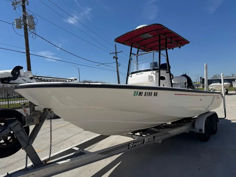 Slide: The Image of 2002 Boston Whaler 220 Dauntless boat on trailer under clear blue sky. - 4