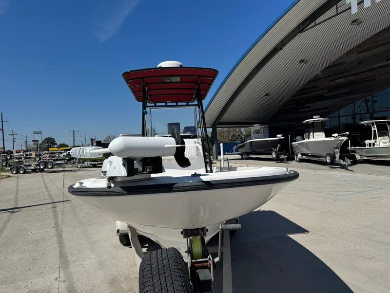 Slide: The Image of 2002 Boston Whaler 220 Dauntless boat on trailer, parked outside dealership. - 5