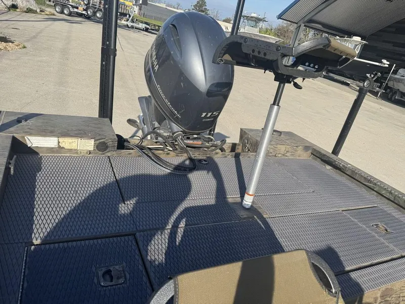 Slide: The Image of 2018 G3 Sportsman 18 Camo boat with Yamaha 115 outboard motor in a parking area. - 10