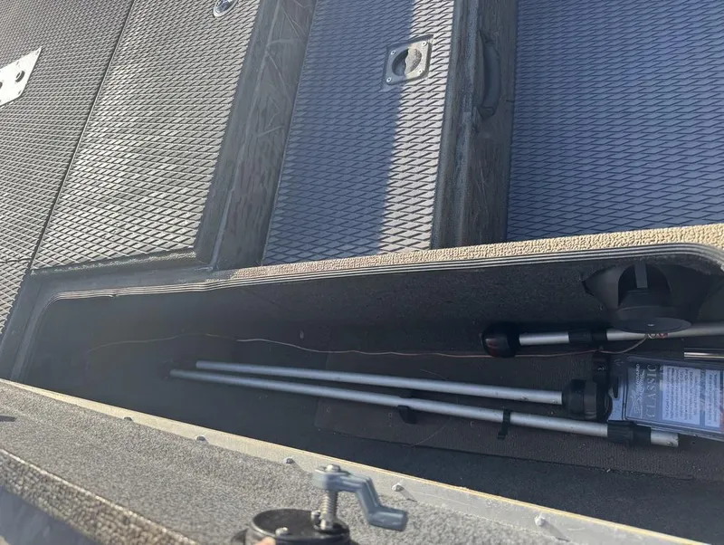 Slide: The Image of 2018 G3 Sportsman 18 Camo boat storage compartment with fishing rods. - 3