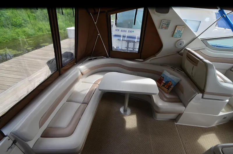 Slide: The Image of Interior of 1994 Regal Commodore 400 boat with curved seating and table. - 10