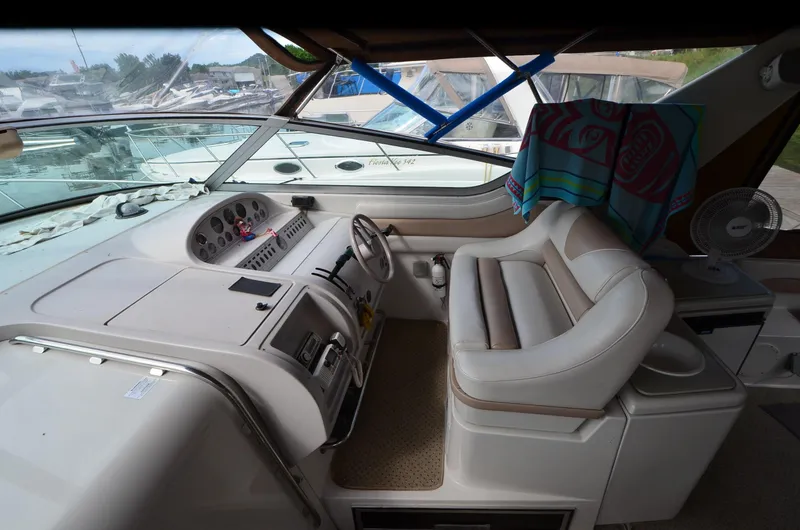 Slide: The Image of Interior of a 1994 Regal Commodore 400 boat with steering wheel and seating area. - 12