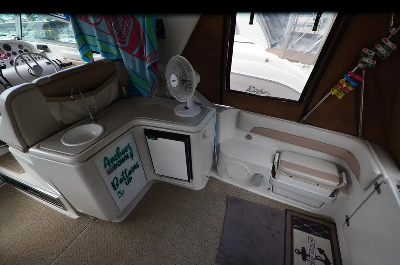 Slide: The Image of Interior of a 1994 Regal Commodore 400 boat with sink, fan, and seating area. - 13
