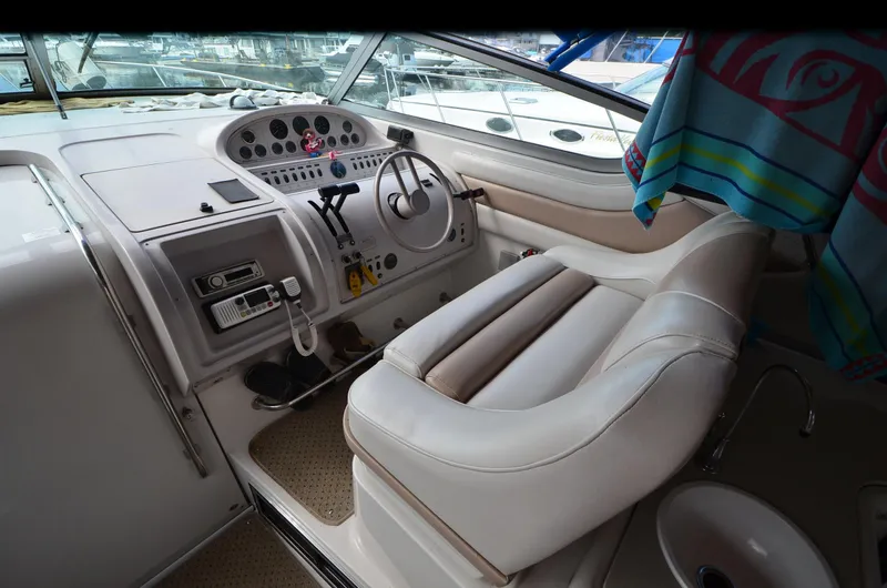 Slide: The Image of Interior of 1994 Regal Commodore 400 boat with steering wheel and control panel. - 14
