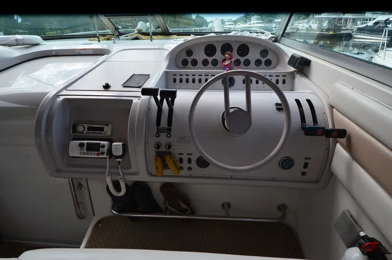 Slide: The Image of Control panel of a 1994 Regal Commodore 400 boat, featuring steering wheel and gauges. - 15