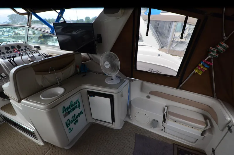 Slide: The Image of Interior of a 1994 Regal Commodore 400 boat with helm, sink, and seating area. - 16