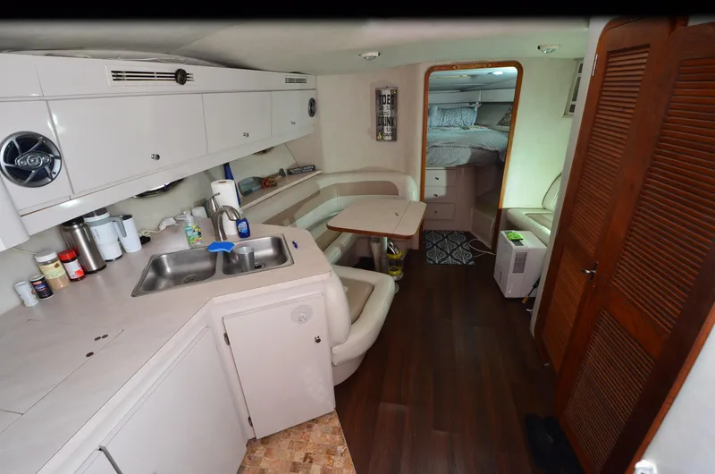 Slide: The Image of Interior of 1994 Regal Commodore 400 yacht with kitchenette and seating area. - 18