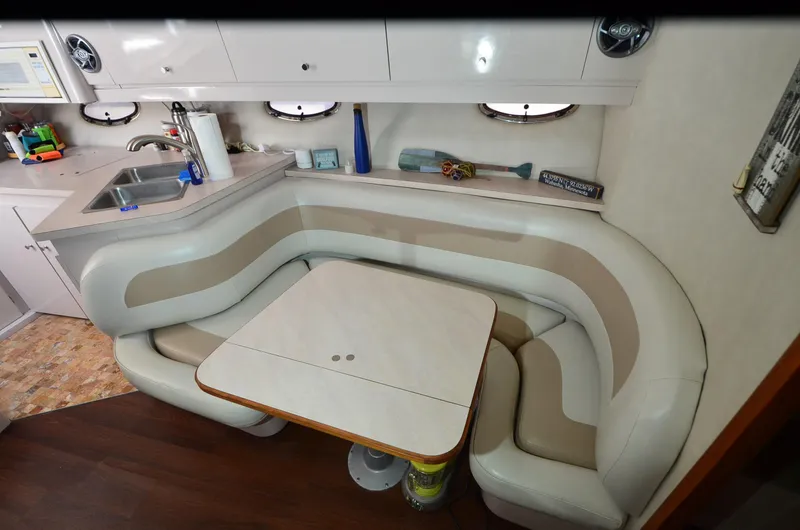 Slide: The Image of 1994 Regal Commodore 400 interior with curved seating, table, and kitchenette. - 21
