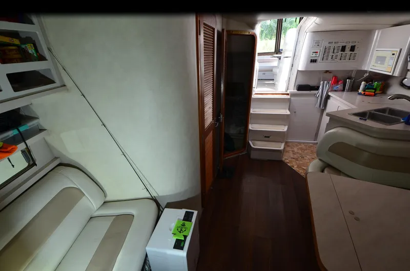 Slide: The Image of 1994 Regal Commodore 400 interior with seating, kitchenette, and stairs. - 23