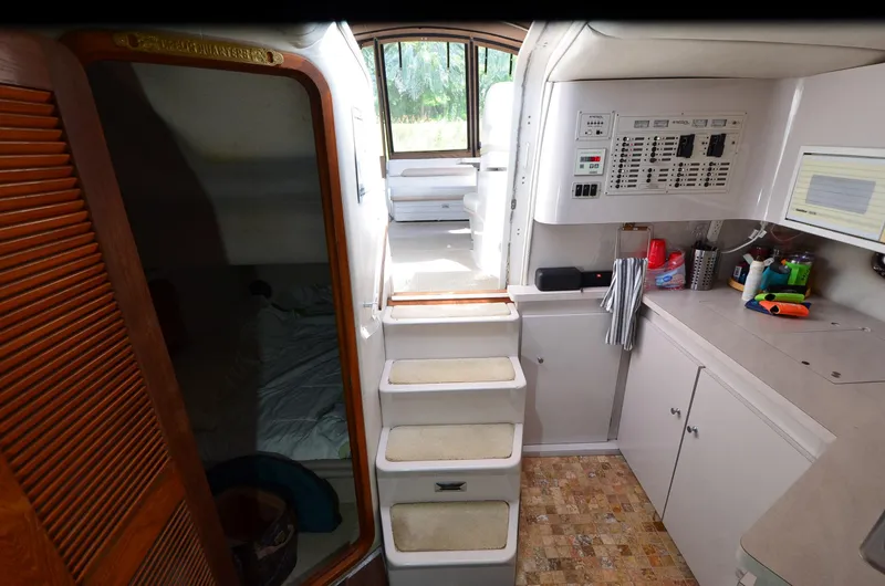 Slide: The Image of Interior of 1994 Regal Commodore 400 yacht with stairs, cabin, and control panel. - 24