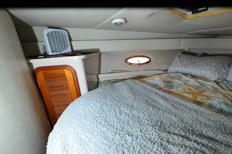 Slide: The Image of 1994 Regal Commodore 400 cabin interior with bed, porthole, and fan. - 27