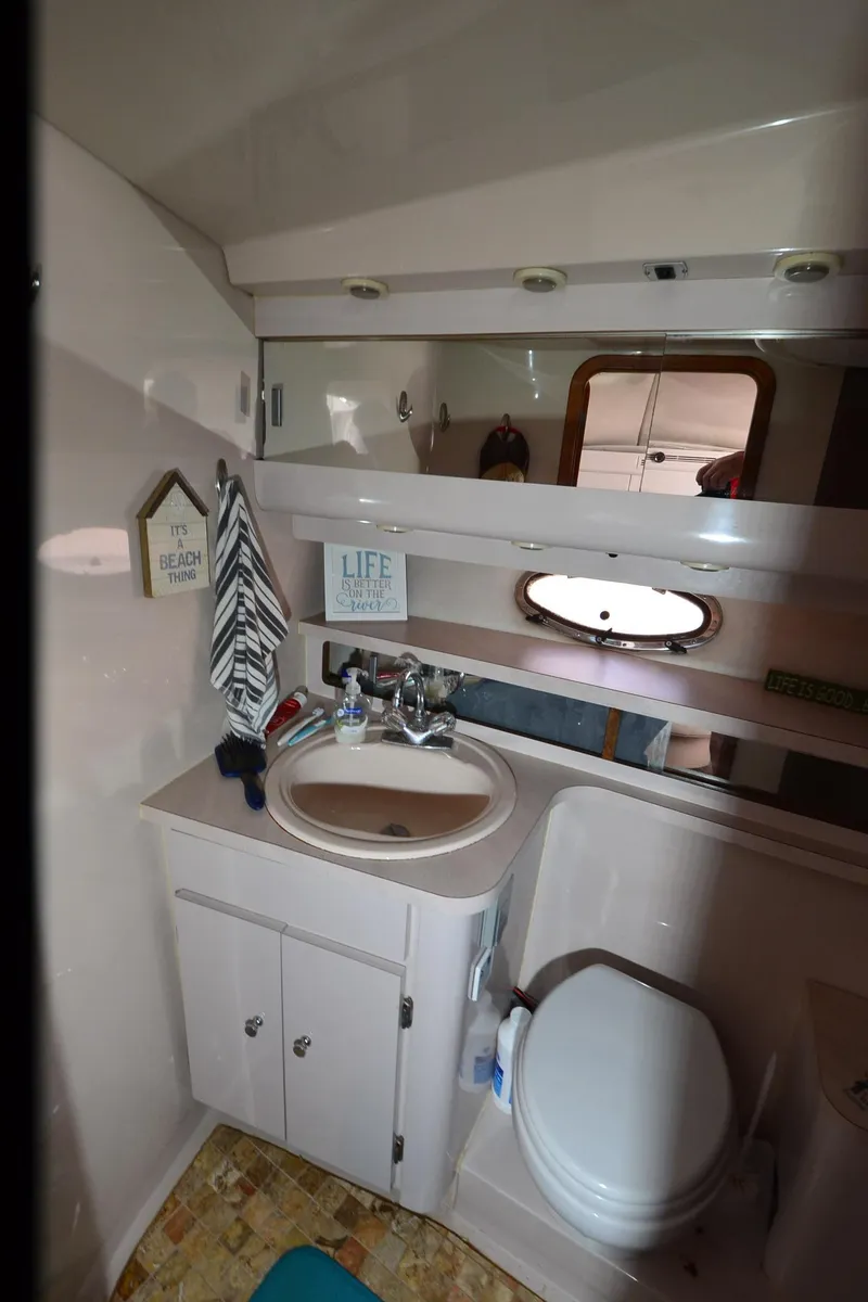 Slide: The Image of Bathroom interior of 1994 Regal Commodore 400 yacht with sink, toilet, and mirror. - 32