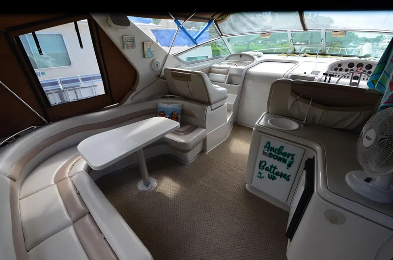 Slide: The Image of 1994 Regal Commodore 400 boat interior with seating, table, and helm. - 9