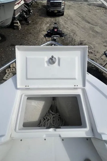 Slide: The Image of 2004 Regulator 24 Forward Seating boat with open storage compartment on deck. - 11