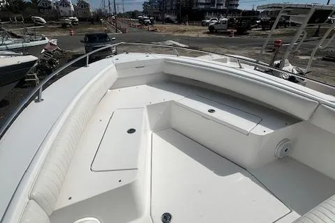 Slide: The Image of 2004 Regulator 24 Forward Seating boat with spacious white deck and seating area. - 12