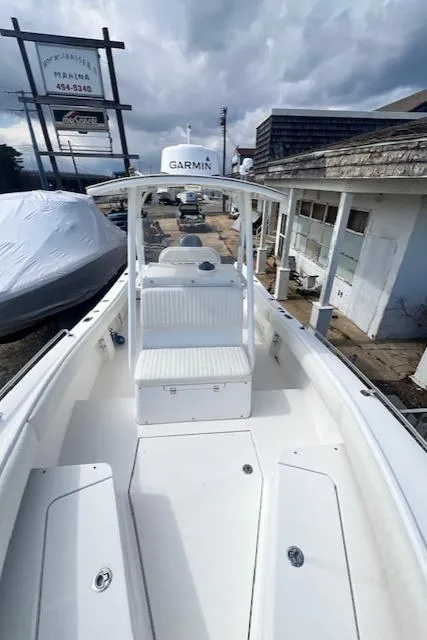 Slide: The Image of 2004 Regulator 24 Forward Seating boat with Garmin equipment, docked at a marina. - 14