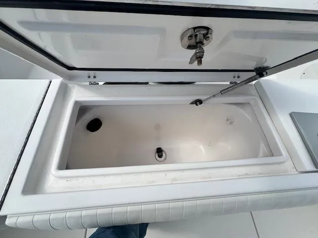 Slide: The Image of Open storage compartment on a 2004 Regulator 24 Forward Seating boat. - 16