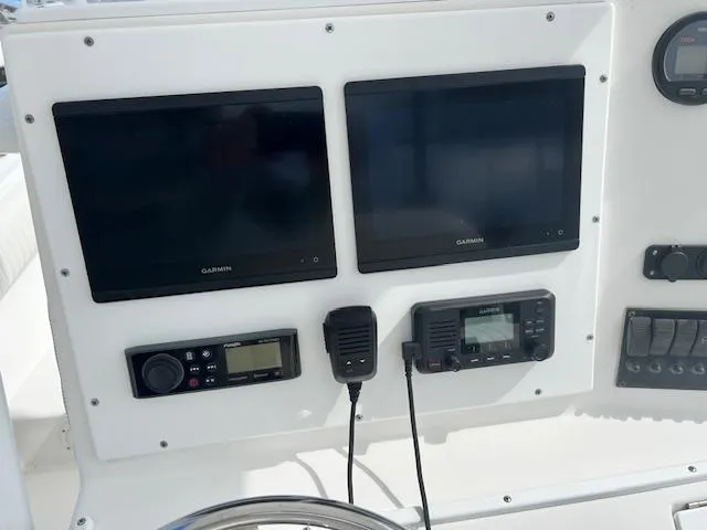 Slide: The Image of Control panel of a 2004 Regulator 24 Forward Seating boat with Garmin displays. - 3