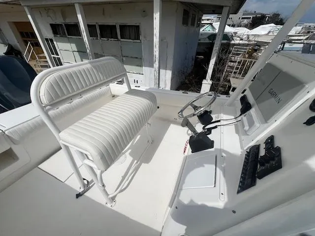 Slide: The Image of 2004 Regulator 24 Forward Seating boat interior with helm and seating. - 6