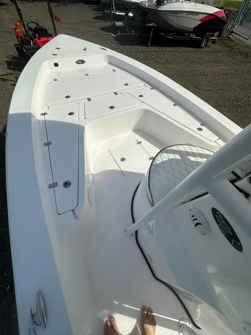 Slide: The Image of 2025 Piranha Casador B2200 boat interior with open storage compartments. - 12
