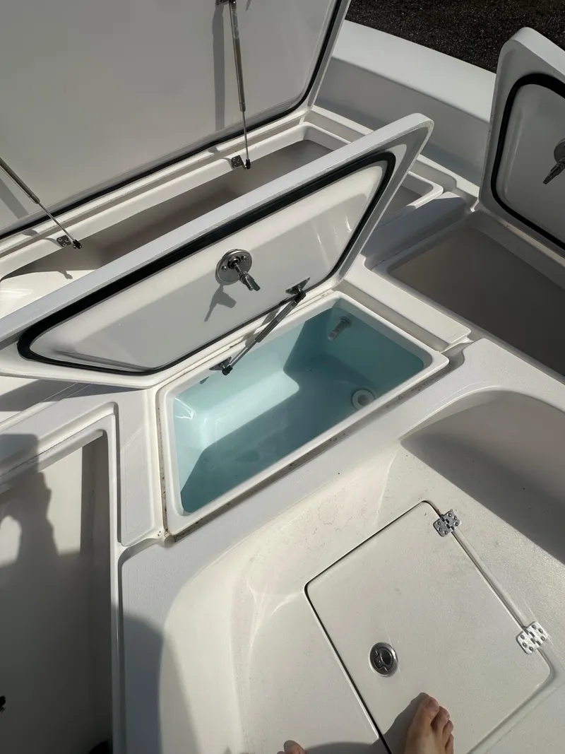 Slide: The Image of 2025 Piranha Casador B2200 boat with open storage compartment and quilted seating. - 14