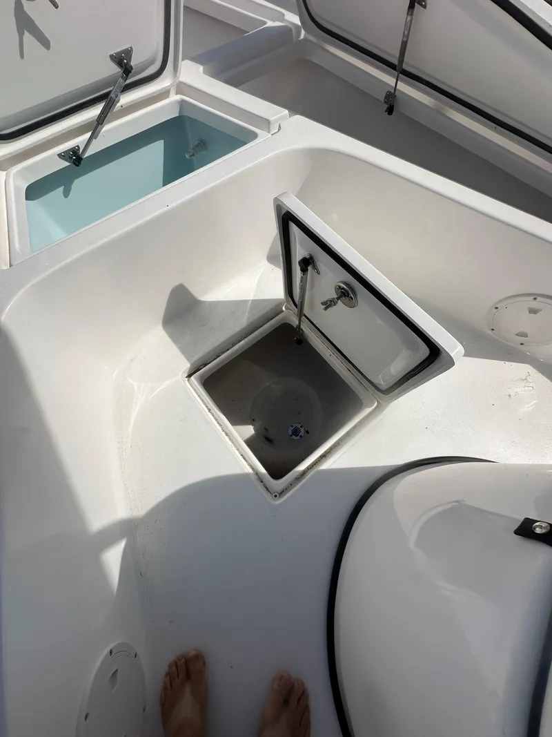 Slide: The Image of 2025 Piranha Casador B2200 boat with T-top, docked under clear sky. - 15