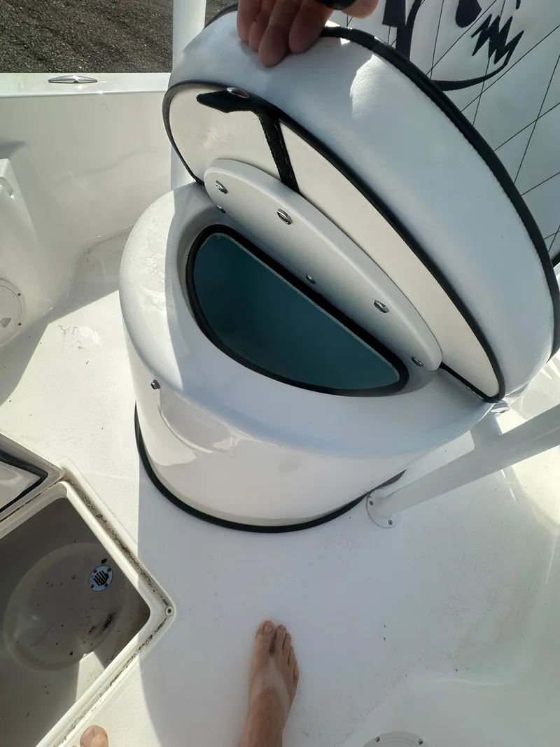 Slide: The Image of 2025 Piranha Casador B2200 boat with steering console and seating, parked outdoors. - 16