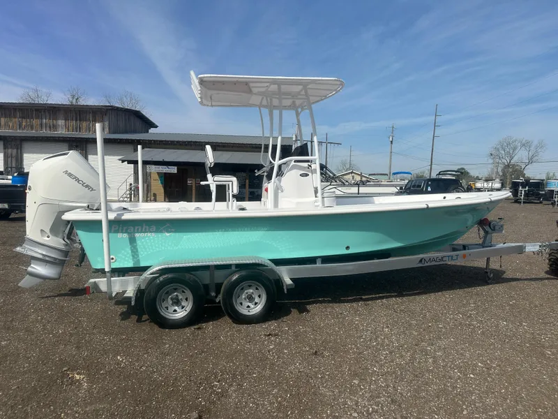 Slide: The Image of 2025 Piranha Casador B2200 boat on trailer, parked outdoors, rear view. - 2