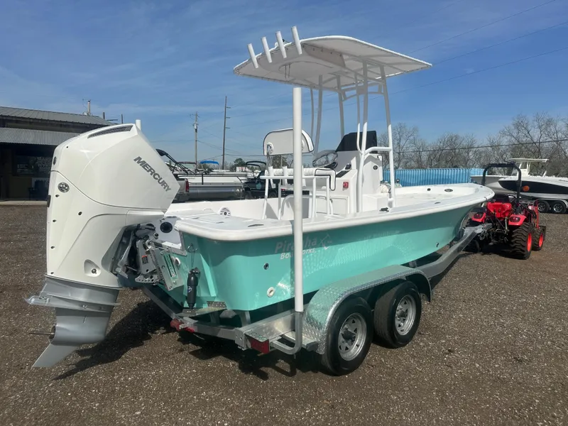 Slide: The Image of 2025 Piranha Casador B2200 boat on trailer, parked outdoors near trees and equipment. - 3