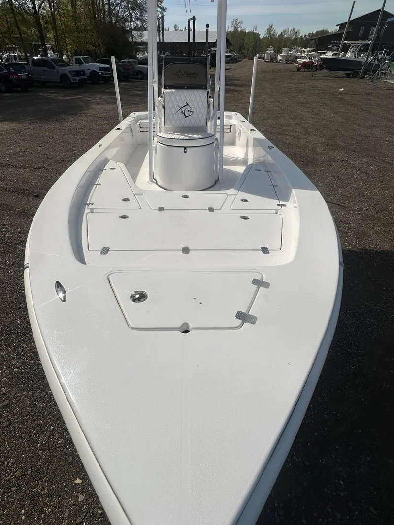 Slide: The Image of 2025 Piranha Casador B2200 boat deck with storage compartments and seating. - 9