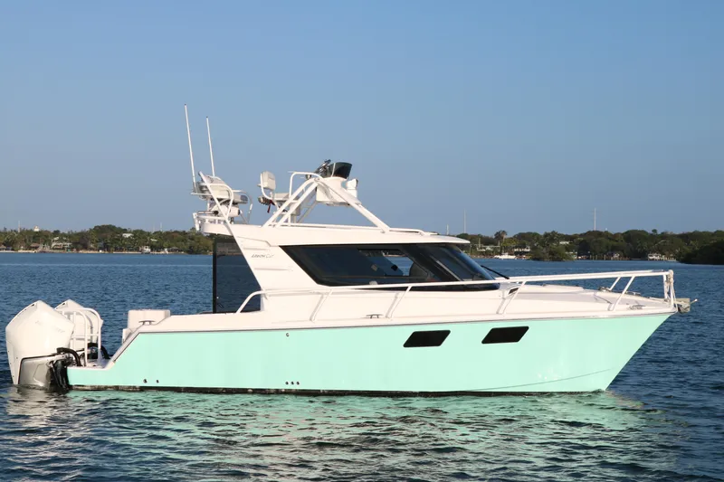 Slide: The Image of 2020 ArrowCat 320 Fly Dual Helm boat on calm water, side view. - 1