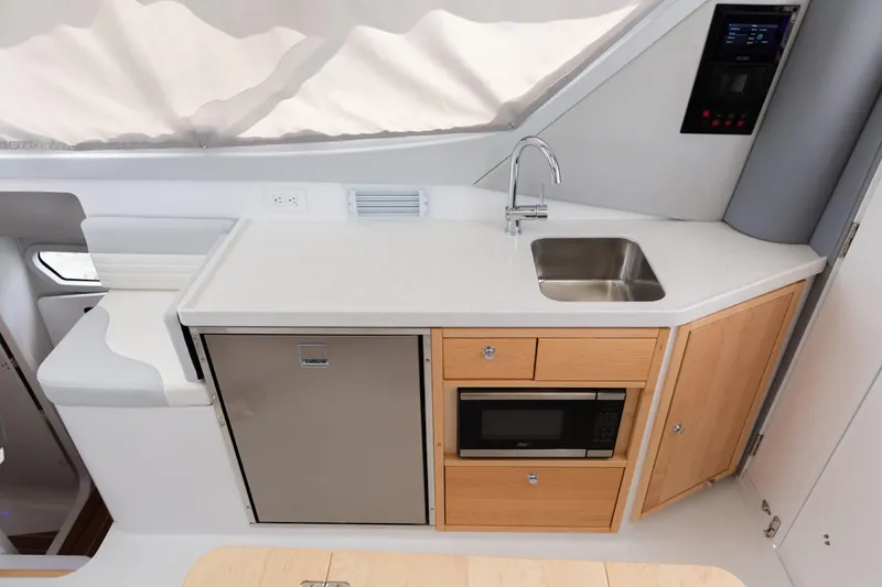 Slide: The Image of Modern galley kitchen in 2020 ArrowCat 320 Fly Dual Helm with sink, fridge, and microwave. - 11