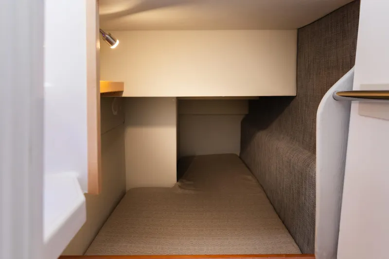 Slide: The Image of 2020 ArrowCat 320 Fly Dual Helm cabin interior with cozy sleeping area and modern design. - 15