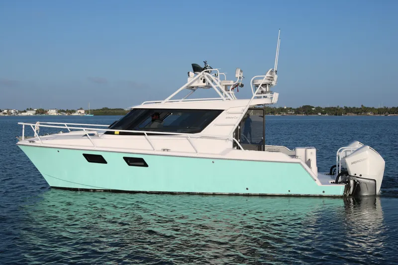 Slide: The Image of 2020 ArrowCat 320 Fly Dual Helm boat on calm water, side view. - 3