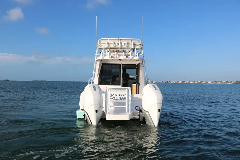 Slide: The Image of ArrowCat 320 Fly Dual Helm 2020 boat on calm water, rear view. - 5