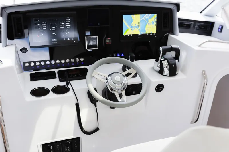Slide: The Image of 2020 ArrowCat 320 Fly Dual Helm boat dashboard with navigation screens and controls. - 6