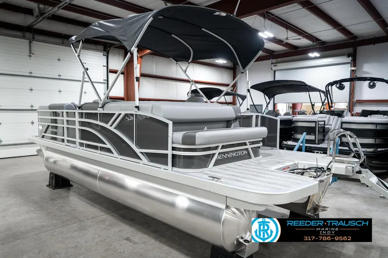Slide: The Image of 2025 Bennington 21 SLJ pontoon boat in showroom with canopy and sleek design. - 10