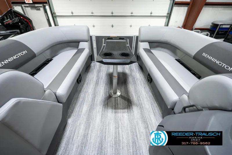 Slide: The Image of 2025 Bennington 21 SLJ boat interior with gray seating and central table. - 21