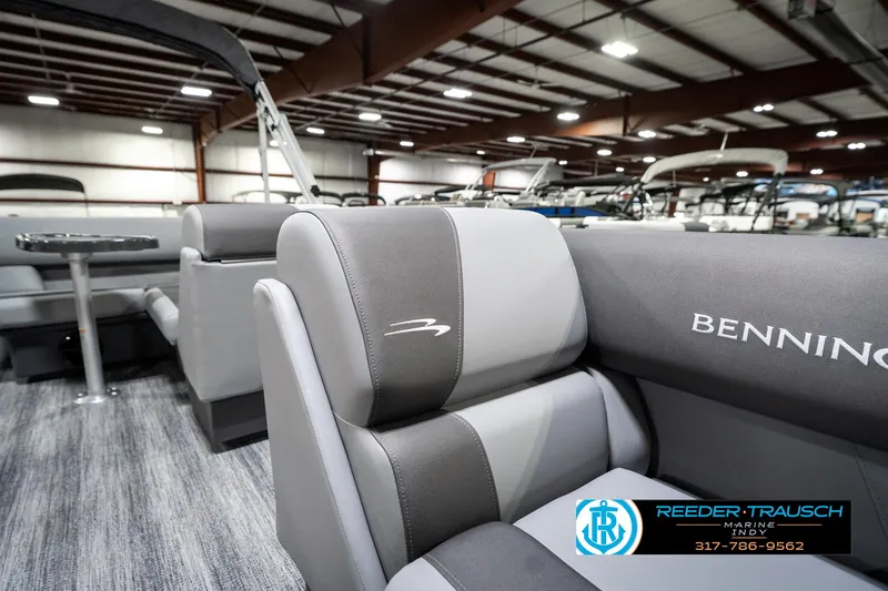 Slide: The Image of 2025 Bennington 21 SLJ pontoon boat interior with gray seating in showroom. - 24