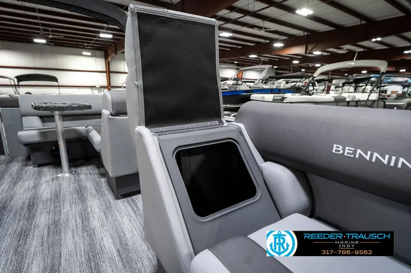 Slide: The Image of 2025 Bennington 21 SLJ boat interior with storage compartment, gray seating, and carpeted flooring. - 25