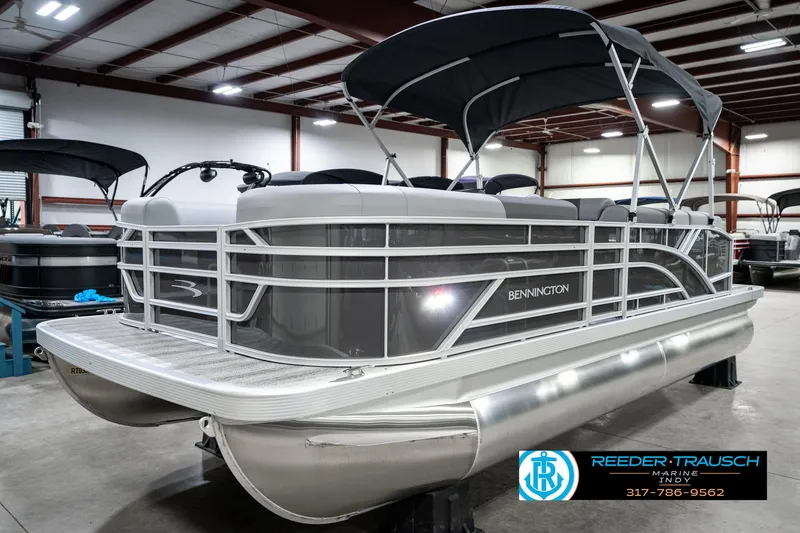 Slide: The Image of 2025 Bennington 21 SLJ pontoon boat in showroom with canopy and sleek design. - 3
