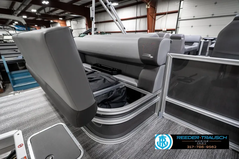 Slide: The Image of 2025 Bennington 21 SLJ pontoon boat with open storage compartment in showroom. - 33